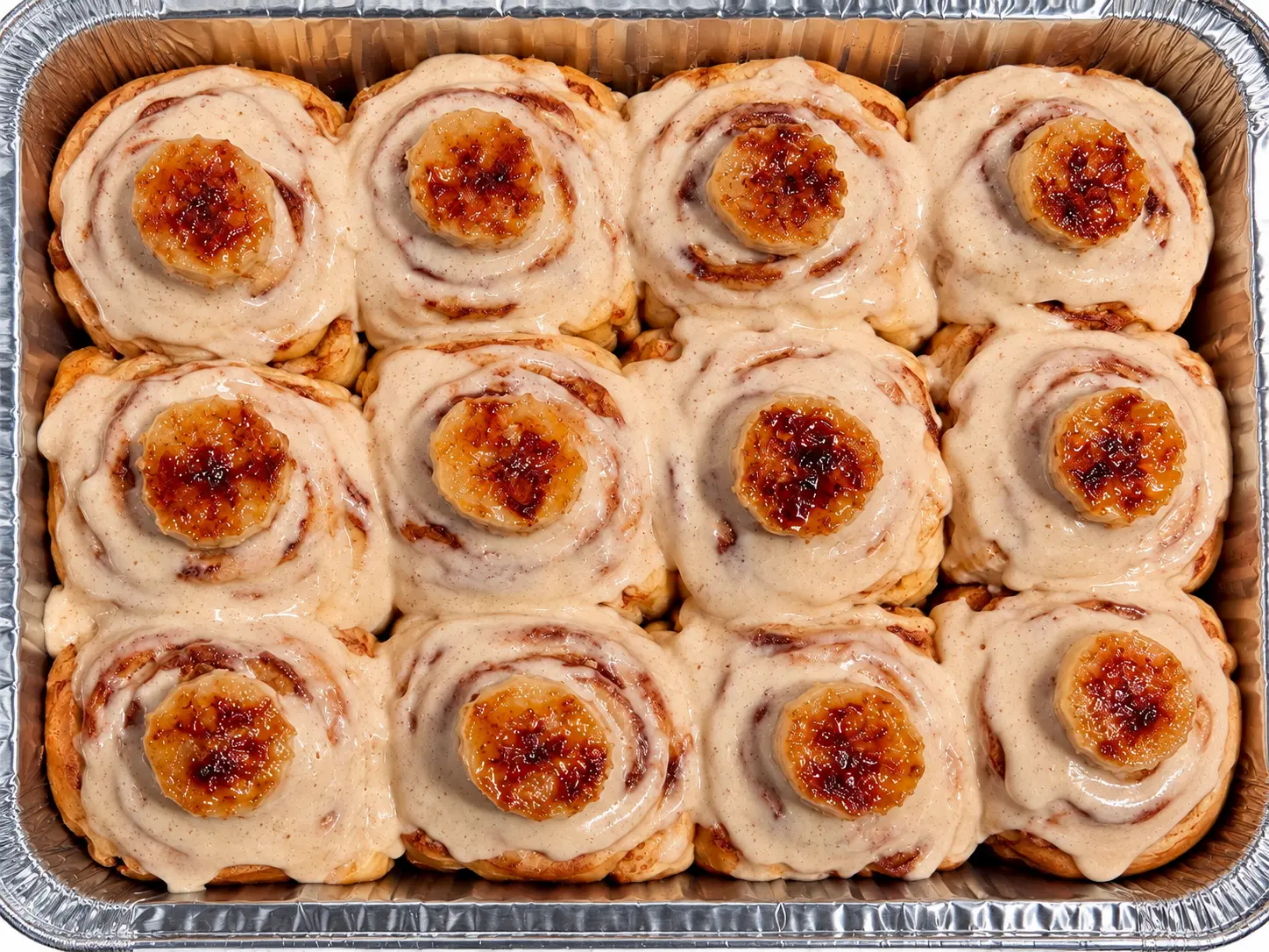 A pan of banana cinnamon rolls topped with caramelized banana